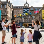 Guests enjoying Edinburgh holiday-let management by exploring vibrant city streets during the Festival Fringe.